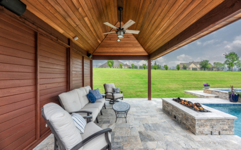 Outdoor seating area by pool with fire pit.