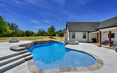 free form pool with blue sky.