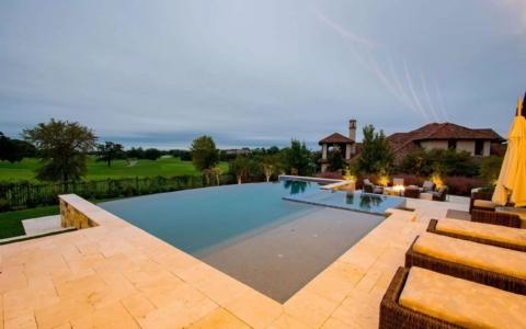 infinity pool in back garden at night.