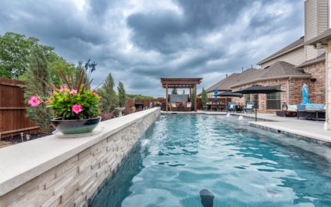 Outdoor pool with outdoor seating area.